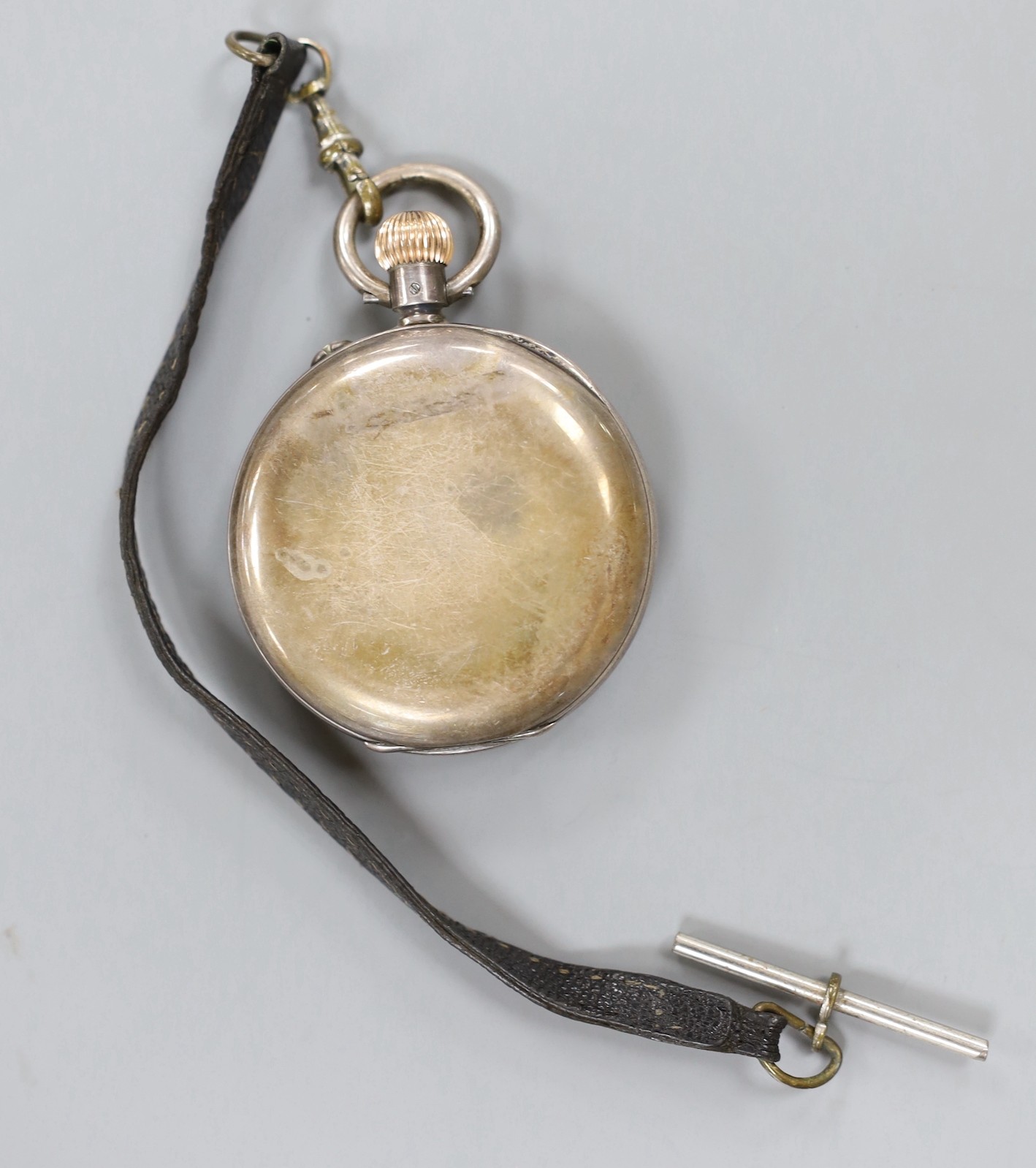A lady's 9ct gold Omega manual wind wrist watch, a 935 white metal fob watch with albert and a silver open faced pocket watch.